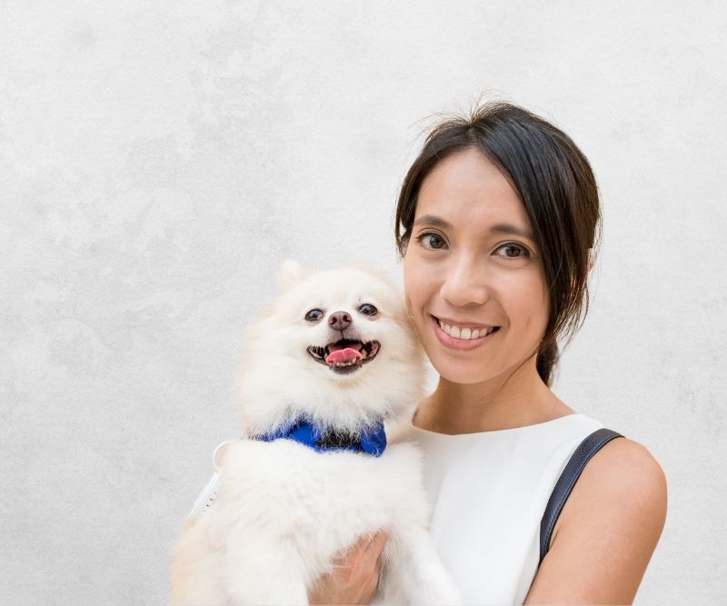 hongkong woman carrying her white dog