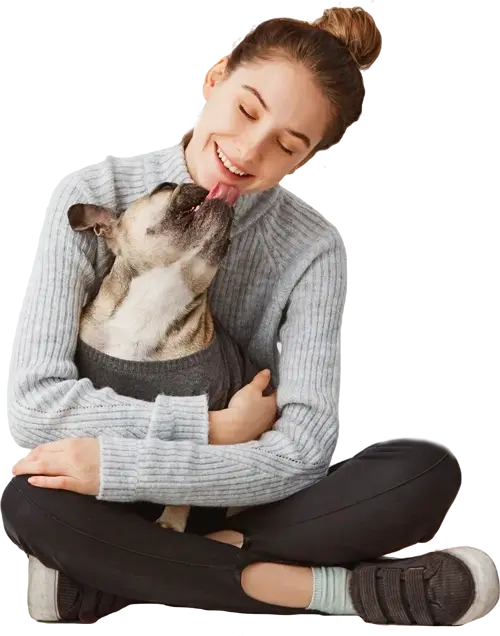 smiling woman holding pug dog in her lap