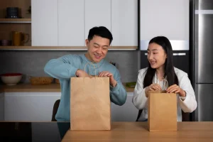hong konger couple taking out something from grocery bags