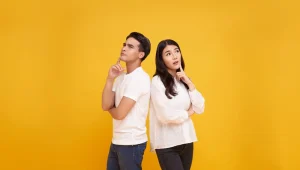 man and woman in yellow backgroundtrying to remember something