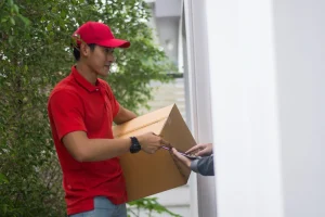 courier man in red shirt and cap delivering parcel to the right person